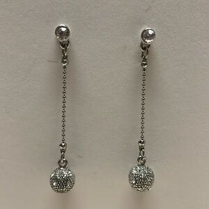 Silver color dangling earrings on a post